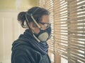 Young woman repairing wattle and daub wall