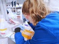 Young woman researcher loading DNA samples to agarose gel Royalty Free Stock Photo