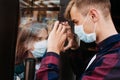 Young woman in a respiratory mask communicates with her boyfriend through a window. Coronavirus covid-19 Royalty Free Stock Photo