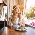 Young woman at restaurant eating shrimp salad. Health food Royalty Free Stock Photo