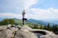 Young woman resting on a big stone in the summer day in the Carpathian mountains Royalty Free Stock Photo