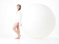 Young woman resting on big, white balloon Royalty Free Stock Photo