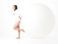 Young woman resting on big, white balloon Royalty Free Stock Photo
