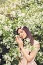 Young woman resting in blossom spring flowers garden Royalty Free Stock Photo