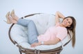 Young woman resting in a comfortable chair.