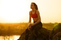 Woman Resting and Drinking Water after Running Outdoor. Workout at Hot Summer Sunset. Sport and Healthy Active Lifesyle.