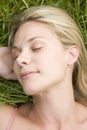 Young woman resting on grass Royalty Free Stock Photo