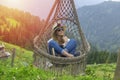 A young woman resting in a hammock in Pokut Plateau