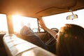 Young woman resting while lying on a front seat of a car Royalty Free Stock Photo