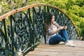 Young woman resting sitting on a wooden bridge Royalty Free Stock Photo
