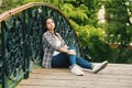 Young woman resting sitting on a wooden bridge Royalty Free Stock Photo