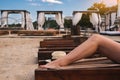 female slender legs on a sun lounger on the beach Royalty Free Stock Photo