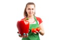 Woman retail or store employee holding red pepper and tomatoes