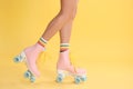 Young woman with retro roller skates on color background Royalty Free Stock Photo