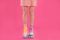 Young woman with retro roller skates on color background Royalty Free Stock Photo
