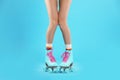 Young woman with retro roller skates on color background Royalty Free Stock Photo