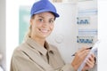 young woman rewrites electrical meter readings Royalty Free Stock Photo