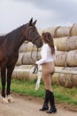 Young woman rider and her beautiful horse