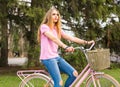 A young girl rides on a bicycle on the road in the park Royalty Free Stock Photo