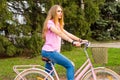 A young girl rides on a bicycle on the road in the park Royalty Free Stock Photo