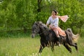 Young woman riding on beautiful horse , having fun in summer time , Romania countryside