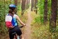 Young woman riding a bicycle in the forest Royalty Free Stock Photo