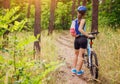 Young woman riding a bicycle in the forest Royalty Free Stock Photo