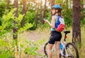Young woman riding a bicycle in the forest Royalty Free Stock Photo