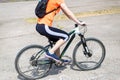 Young woman is riding a bicycle, rear view. Royalty Free Stock Photo