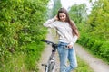 Young woman riding bicycle in summer city park outdoors. Active people. Hipster girl relax and rider bike Royalty Free Stock Photo