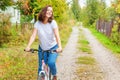 Young woman riding bicycle in summer city park outdoors. Active people. Hipster girl relax and rider bike. Cycling to work at Royalty Free Stock Photo