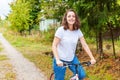 Young woman riding bicycle in summer city park outdoors. Active people. Hipster girl relax and rider bike. Cycling to work at Royalty Free Stock Photo