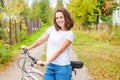 Young woman riding bicycle in summer city park outdoors. Active people. Hipster girl relax and rider bike. Cycling to work at Royalty Free Stock Photo