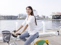 Young woman riding bike in city park Royalty Free Stock Photo