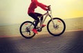 Young woman riding bike on seaside Royalty Free Stock Photo