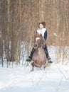 A young woman riding a brown horse Royalty Free Stock Photo