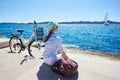 Young woman riding city bicycle near sea