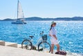 Young woman riding city bicycle near sea