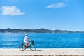 Young woman riding city bicycle near sea Royalty Free Stock Photo