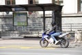 A young woman riding a fast motorbike on city street