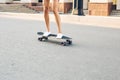 Young woman riding on her skateboard. Female skater practicing skating on the city. Royalty Free Stock Photo