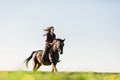 Young woman riding a horse on field Royalty Free Stock Photo