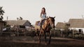 Young woman riding a horse on a lunging rein