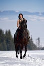 Young woman riding horse outdoor in winter Royalty Free Stock Photo