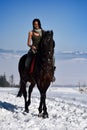 Young woman riding horse outdoor in winter Royalty Free Stock Photo