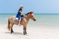 Young Woman riding horse in the sand beach Royalty Free Stock Photo