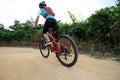 Woman riding mountain bike on forest trail Royalty Free Stock Photo