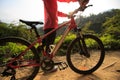 Woman riding mountain bike on forest trail Royalty Free Stock Photo