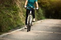 Woman riding mountain bike on forest trail Royalty Free Stock Photo