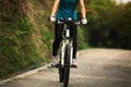 Woman riding mountain bike on forest trail Royalty Free Stock Photo